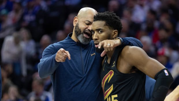 Feb 15, 2023; Philadelphia, Pennsylvania, USA; Cleveland Cavaliers head coach J.B. Bickerstaff talks with guard Donovan Mitchell (45) during a break in the second quarter against the Philadelphia 76ers at Wells Fargo Center. Mandatory Credit: Bill Streicher-USA TODAY Sports
